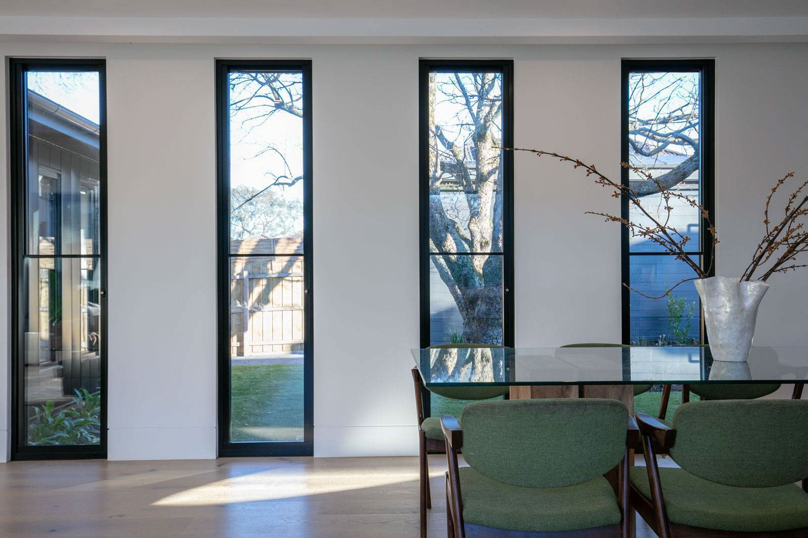 Modern dining space with tall windows